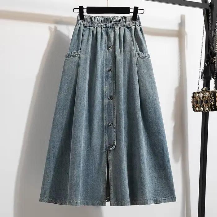 Jupe demi-corps en denim délavé de couleur unie. Une nouvelle jupe en jean longue fendue avec un des