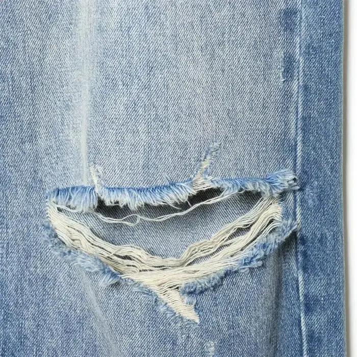 Nouvelles collections 2026 : Jean décontracté français pour femme avec détails perforés et taille mi-haute plissée