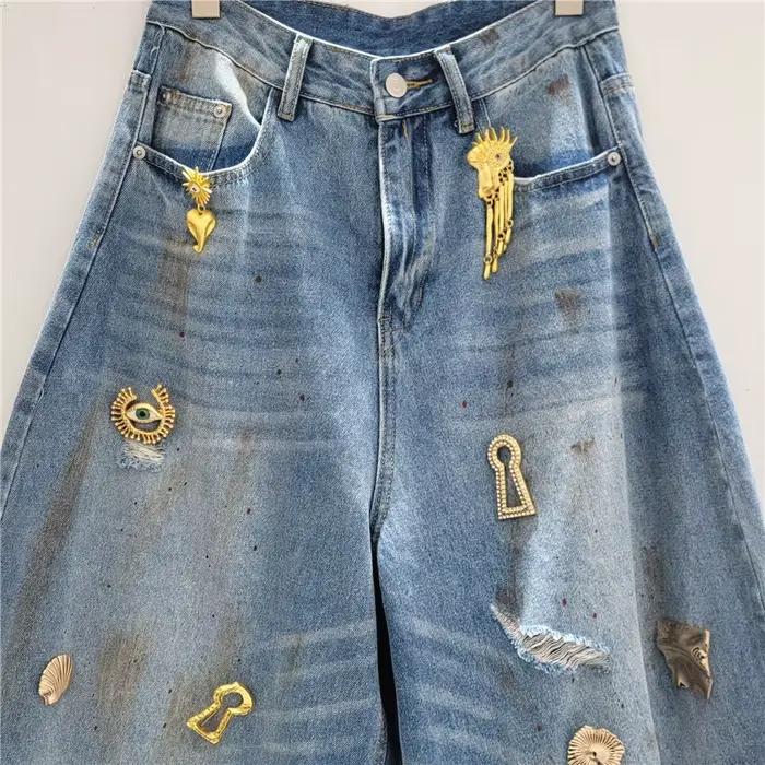 Jean Taille Haute Ample avec Trou Déchiré et Décoration Métallique Denim Pantalon Banane Nouvelle Mode Printemps 2026 DEAT